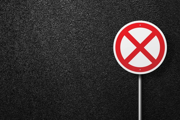 Road sign of the circular shape on a background of asphalt. The texture of the tarmac, top view.