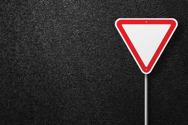 Road sign of the triangular shape on a background of asphalt. Give way. The texture of the tarmac, top view. — Stock Photo, Image