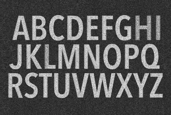 El alfabeto latino en forma de una marca en el pavimento — Foto de Stock