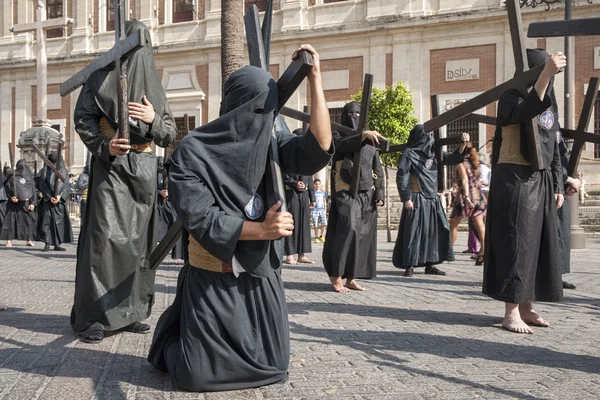 Botgörare med sitt kors, heliga veckan i Sevilla Nazarene broderskap av studenter — Stockfoto