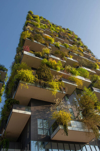 milan italy march 29 2021: Bosco Verticale "new and modern skyscraper with trees growing on the balconies, in the Isola district of Milan which is reflected in the water of the fountain