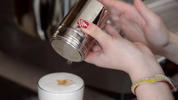 Налить корицу в чашку кофе — стоковое видео