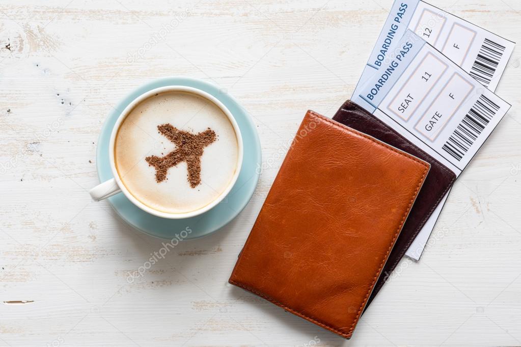 Aircraft made of cinnamon in cappuccino, passports and boarding pass
