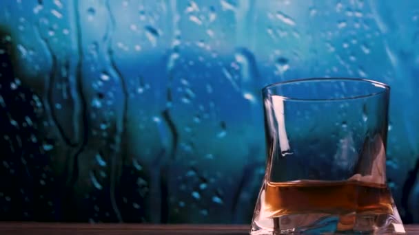 窗边的酒吧里有一杯威士忌 窗边有一杯带着雨水的白兰地 — 图库视频影像
