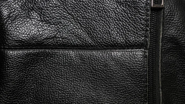 Genuine leather with a sewn-in zipper, brown genuine leather. Leather texture close-up
