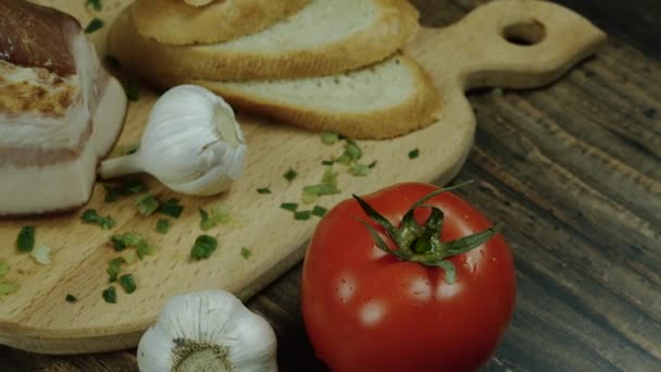 家里做的食物放在木制盘子里 新鲜的西红柿配咸肉和大蒜 在厨房里烹调 新鲜天然产品 — 图库视频影像