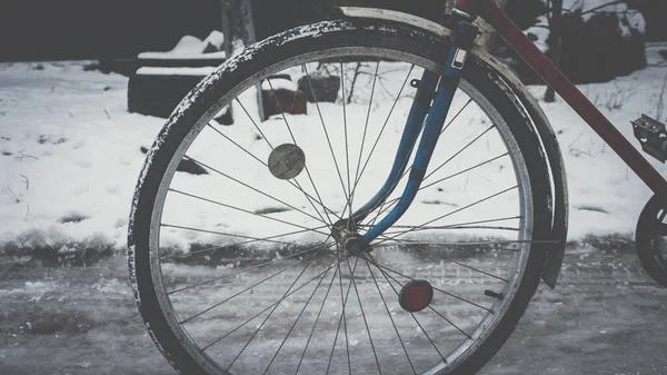 Road bike vintage, retro bike on winter snowy road, bike wheel
