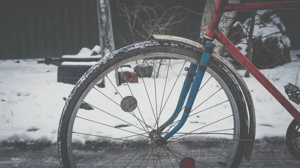 Retro bike scratched, vintage bike, bicycle wheel on a winter road