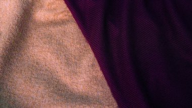 Background in pastel shades of coffee shade with purple silk fabric. Textile, copy space from silk fabric. Background for text.