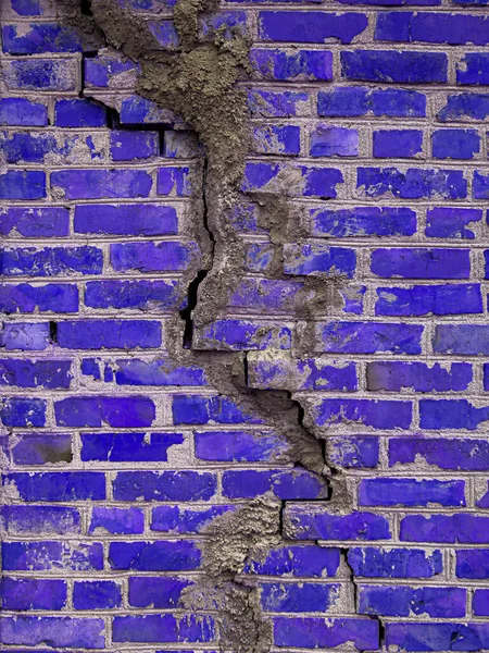 Brick wall texture with cracked blue color. Destroyed ancient wall. Brick background copy space