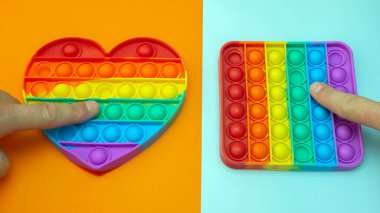 Stres önleyici. Popüler bir stres giderici oyuncak. LGBT kalp bayrağı. Parmağını silikon oyuncak antistrese bastırıyorsun. Patlat..