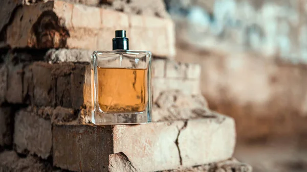 Men's perfume on a brick wall background, perfume jar on vintage bricks