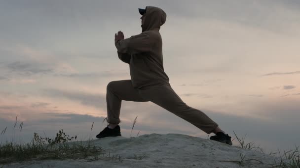 Man Practices Yoga Outdoors Beautiful Sunset Pilates Nature Athletic Man — Stock Video