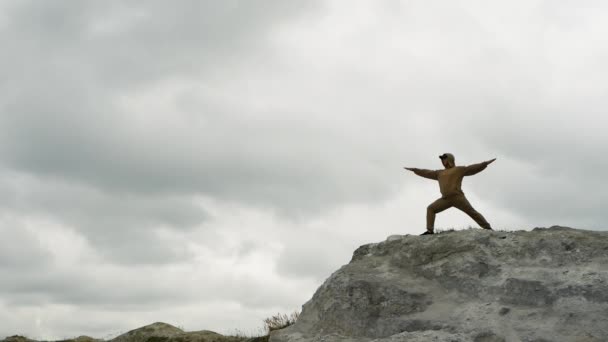 Man Does Yoga Top Mountain Background Gray Rainy Clouds Man — Stock Video