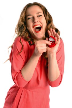 Surprised beautiful young woman holding  an open jewelery gift box. Isolated on white