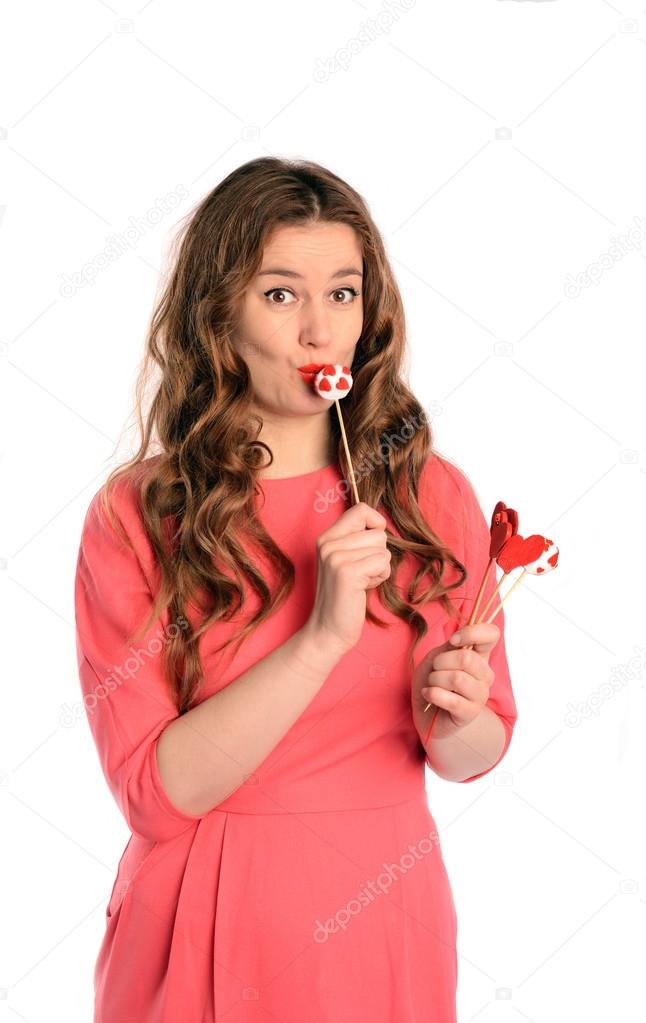 Surprised Brunette long hair young woman kissing cake pop. Isolated on white background