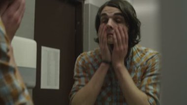 genç adam onun ellerini ve yüzünü yıkar