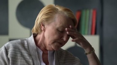 sick elderly woman coughing and feels very bad