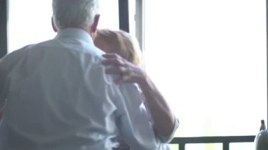 Active retirement and leisure activities, happy dance of an elderly couple. Husband kisses wife