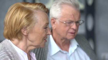 Yaşlı çift rahat oturma odasında internette aile ile iletişim içinde eğleniyor