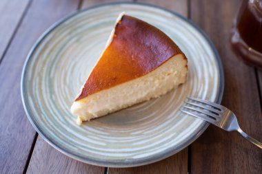 Cheescake San Sebastian kafe masasında yemeği dilimliyor.