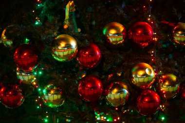 Noel ağacında asılı kırmızı ve sarı Noel balosu süslemesi.