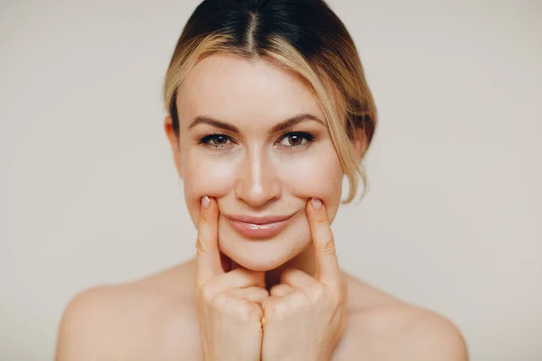 Young adult doing facial gymnastics self massage and rejuvenating exercises face building for skin and muscles lifting — Stock Photo, Image