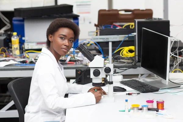 Scientist african american woman working in laboratory with electronic instruments