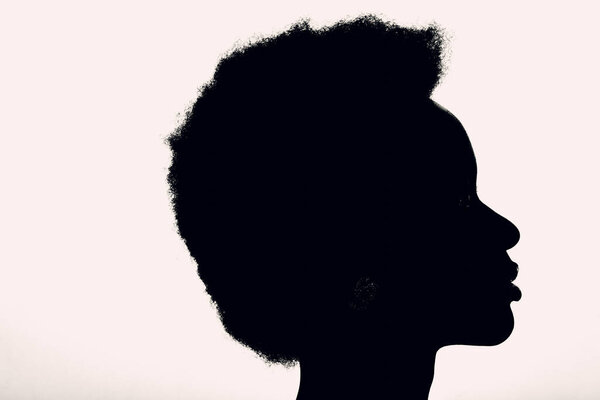 Close up portrait of african american woman with afro hairstyle on white studio background