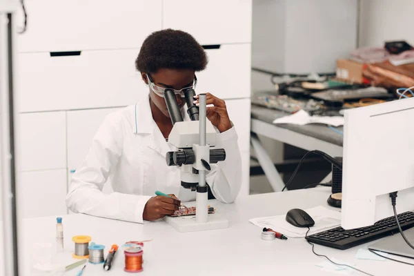 Scientist african american woman working in laboratory with electronic instruments