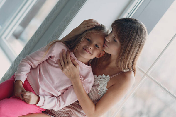 Mother and little daughter child girl at home.