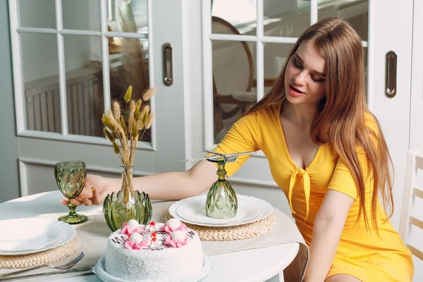 Wanita muda kesepian duduk dan membosankan sendirian di rumah atau kafe dengan kue ulang tahun putih — Stok Foto