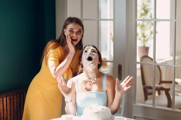 stock image Young woman dips face in white cake with cream. Happy birthday concept.