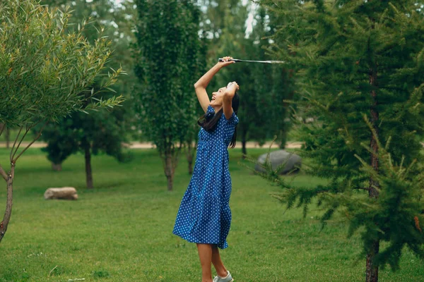 Giovane donna adulta che gioca a badminton nel parco — Foto Stock