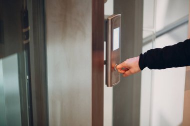 Koronavirüs pandemik covid-19 karantina konsepti sırasında işaret parmağıyla asansöre bas.