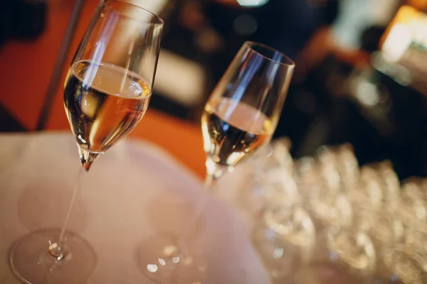 Dois copos de champanhe com bolhas em uma mesa em um restaurante — Fotografia de Stock