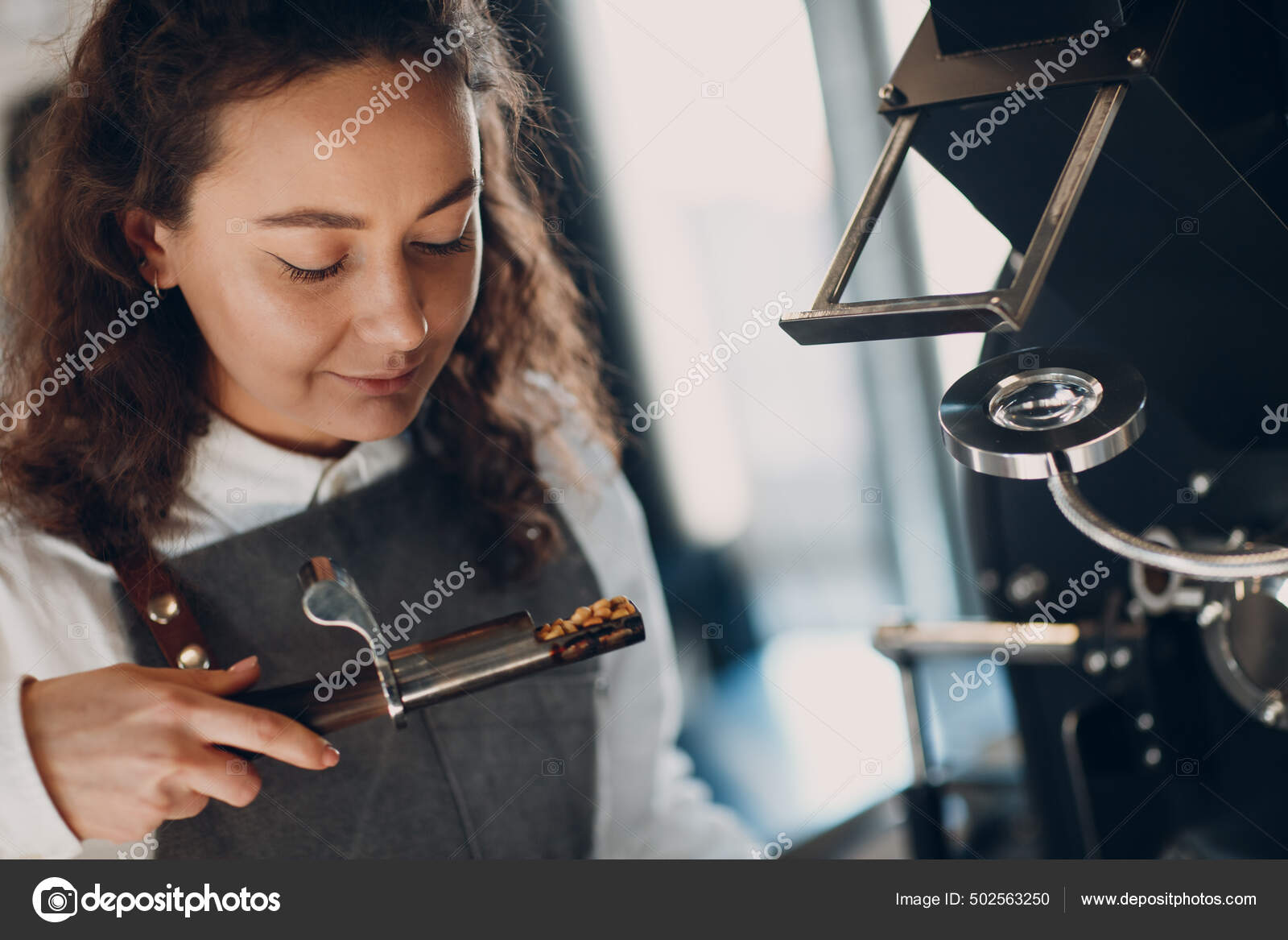 Coffee roaster machine and barista smell with tryer at coffee roasting process Stock Photo by