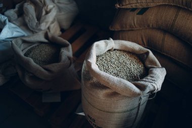 Kızartma şirketinde çuval içinde yeşil kahve çekirdekleri.