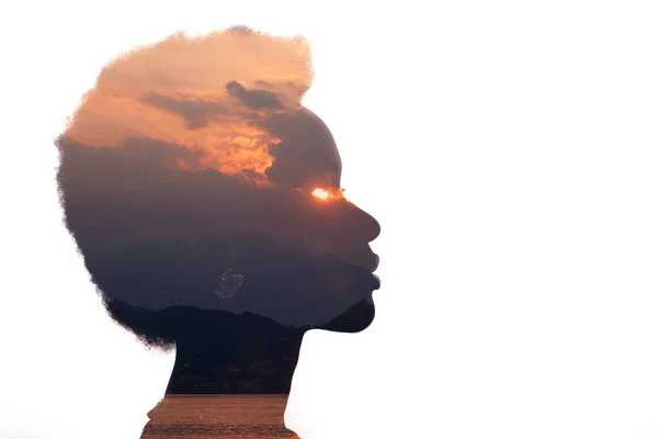 Multiple exposure sunrise and sea inside woman silhouette. Psychology concept
