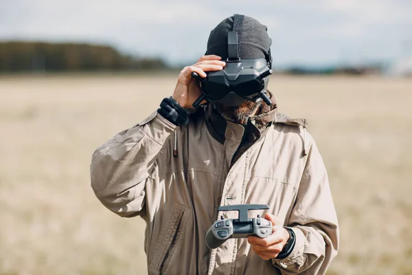 Man controlling fpv quadcopter drone with goggles antenna remote controller — Stock Photo, Image