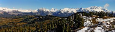 Panoramic view of snow-capped mountains clipart