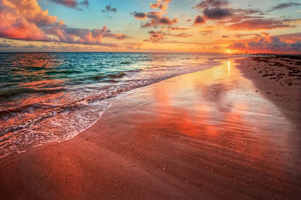 Zonsondergang over een oceaan strand kust — Stockfoto