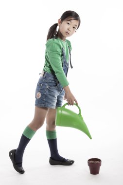 Aracı ve çiçek pot sulama ile bir çocuk