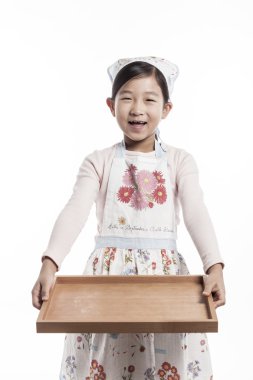 A child in a kitchen. clipart