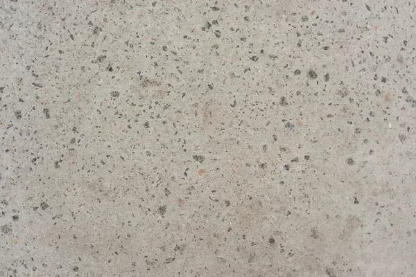 Küçük taşlarla arka plan dokusu ile kaba gri beton duvar