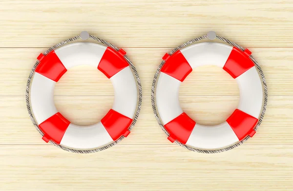 Two red lifebuoys hanging on a wooden wall. — Stock Photo, Image
