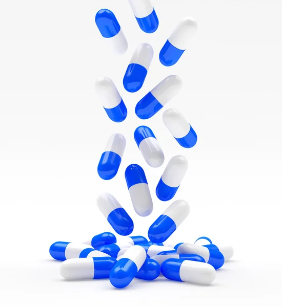 Falling medical blue capsules on white — Stock Photo, Image