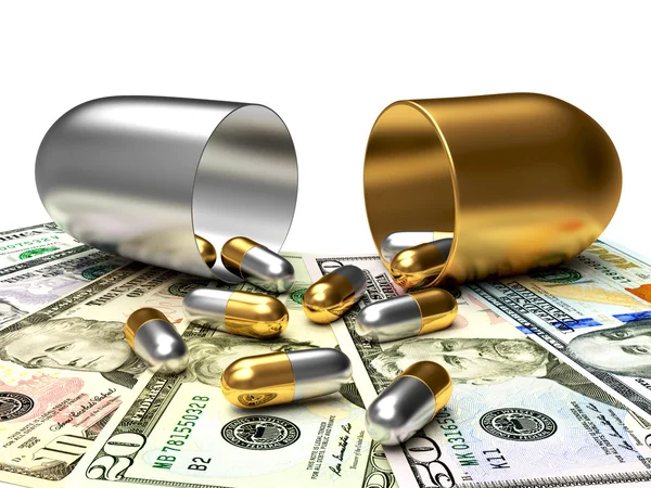 Medicinska golden och silver kapslar började forsa ut ur en öppen kapsel på dollarsedlar. — Stockfoto