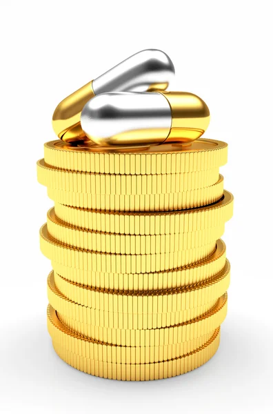 Medicinska kapslar på en stack av gyllene mynt på vit — Stockfoto