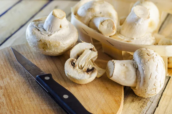 Fresh champignons on a wooden Board — Stock Photo, Image